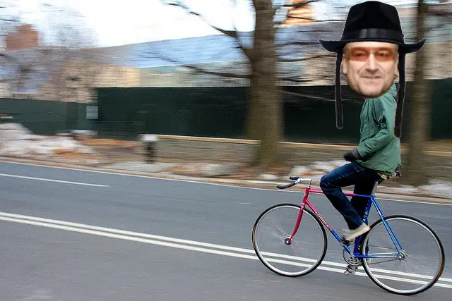 A rendering of Bono dressed as a Hasidic Jew cycling through Central Park